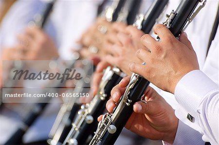 Group of young musicians playing on clarinets