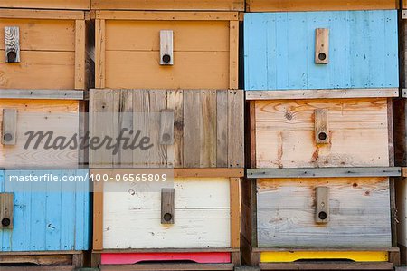 Detail of brand new multicolored wooden beehive boxes