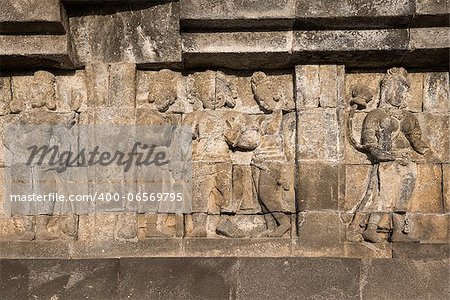 Detail of Buddhist carved relief at Borobudur temple on Java, Indonesia