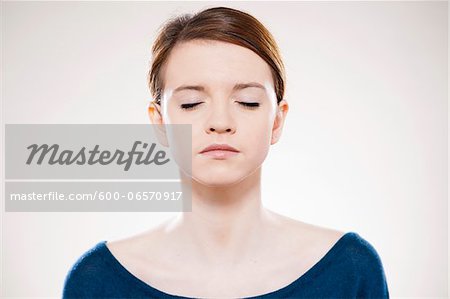 Head and Shoulders Portrait of Teenage Girl with Eyes Closed in Studio