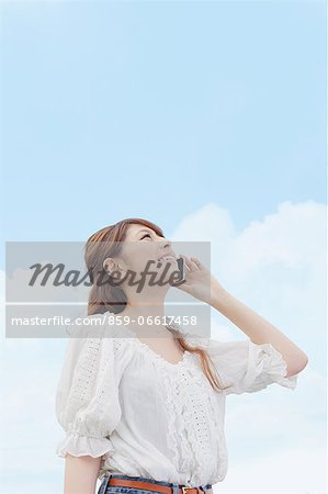 Woman On the Phone Looking at the Sky