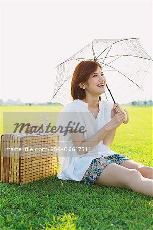 Woman Holding a Parasol In Meadow