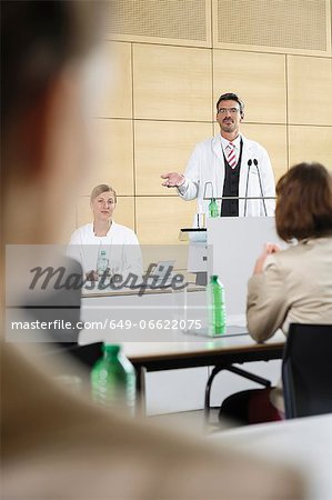 Doctors giving talk in conference room