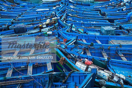 Blue boats docked in harbor