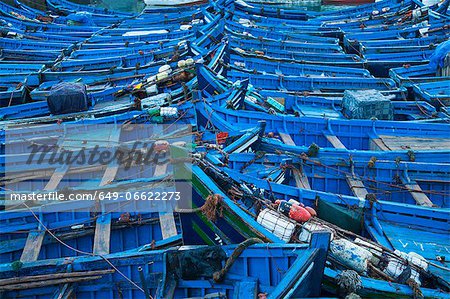 Blue boats docked in harbor Blue boats docked in harbor