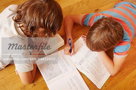 Boys studying together on floor