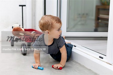Boy crawling out back door