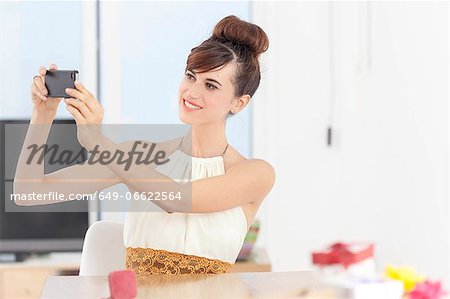 Woman taking picture with cell phone