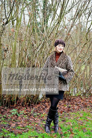 Smiling woman standing in forest