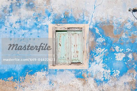 Dilapidated window, shutters and wall Dilapidated window, shutters and wall