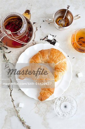 Croissants, honey and tea on table Croissants, honey and tea on table
