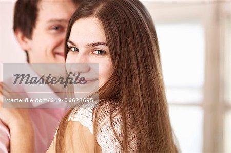 Smiling couple hugging indoors