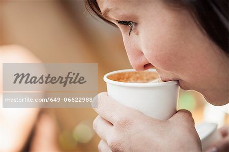 Close up of woman drinking cup of coffee