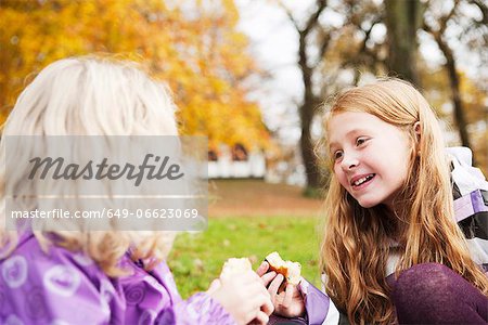 Girls eating together outdoors