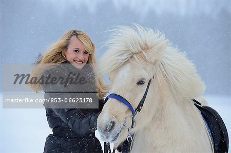 Young woman with horse in snow, Upper Palatinate, Germany, Europe