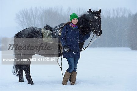 Young woman with arabo haflinger horse in snow, Upper Palatinate, Germany, Europe