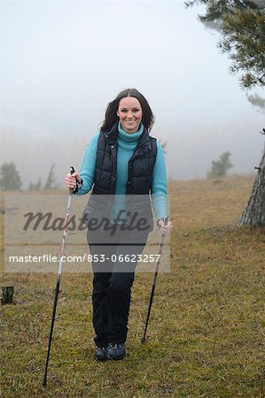 Brunette young woman Nordic walking