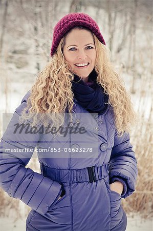 Blond woman wearing winther clothes outdoors