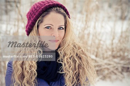 Blond woman wearing winther clothes outdoors, portrait