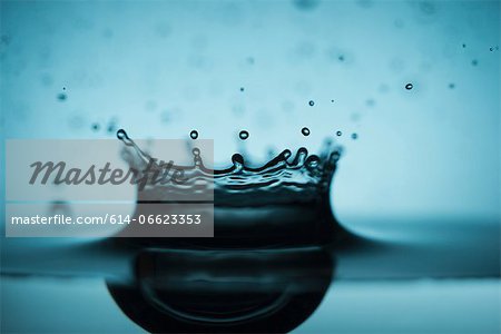 Close up of drop splashing in water