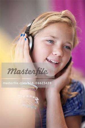 Smiling girl listening to headphones