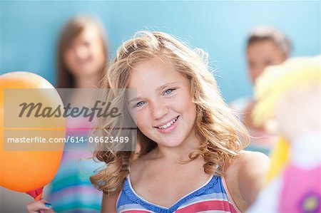 Smiling girl holding balloon