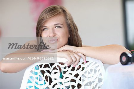 Teenage girl resting chin on hand