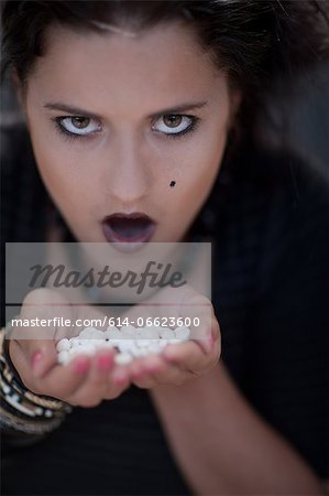 Angry teenage girl holding pills