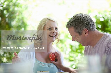 Man holding heart over wife's chest