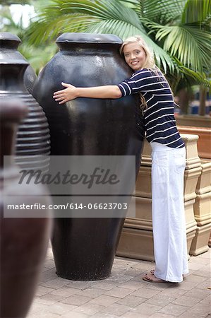 Woman hugging large planter