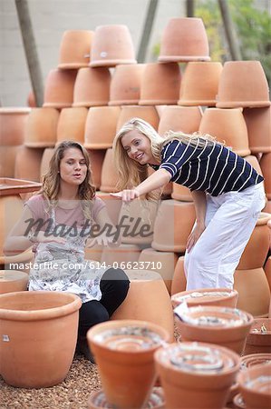 Woman shopping for planters in nursery