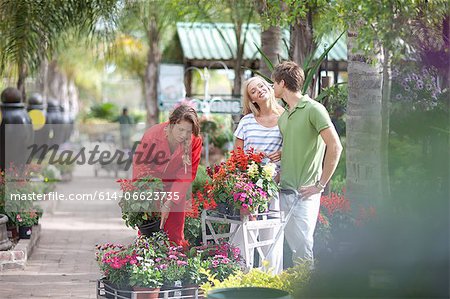 Friends shopping for plants in nursery