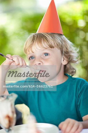 Boy having ice cream sundae at party