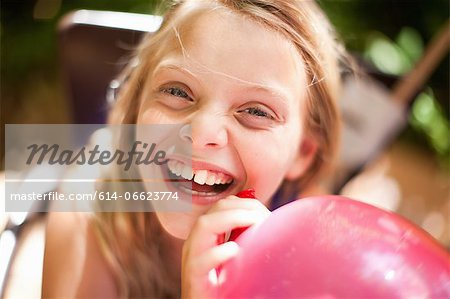 Smiling girl holding balloon at party