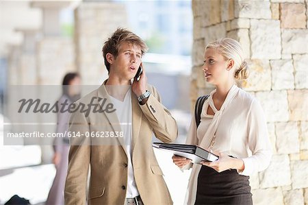 Business people standing in walkway