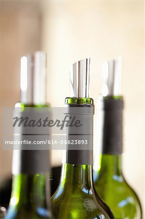 Close up of metal corks in wine bottles