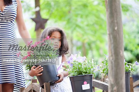 Girl carrying planter outdoors