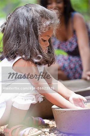 Girl playing in planter