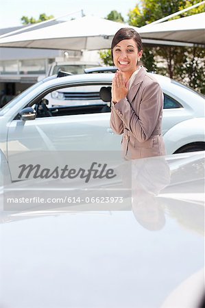 Excited woman cheering at car dealership