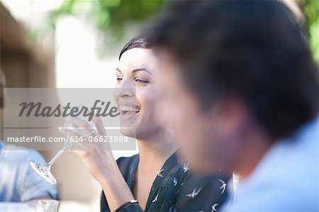 Friends having drinks at table outdoors