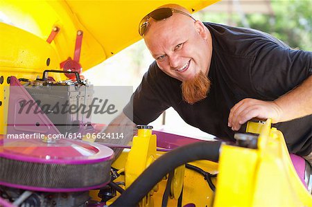 Mechanic working on colorful car