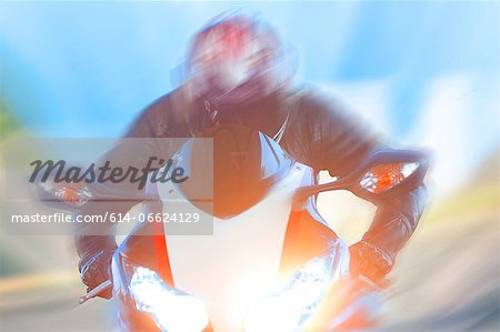 Blurred view of man riding motorcycle