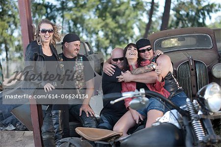 Friends relaxing by vintage cars Friends relaxing by vintage cars