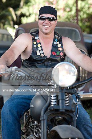 Man in leather vest on motorcycle