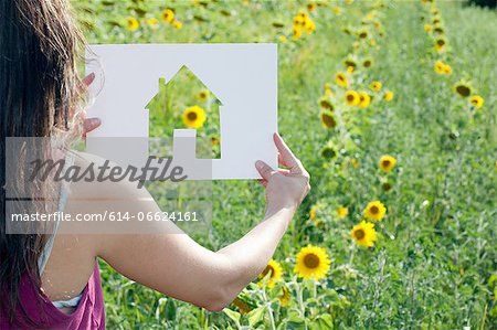Woman holding card with house shape