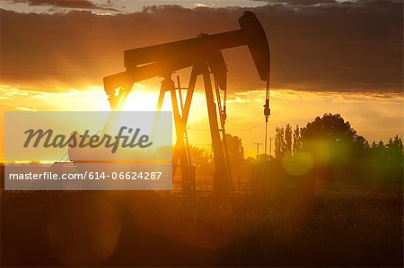 Silhouette of oil wells at sunset Silhouette of oil wells at sunset
