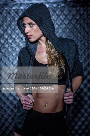 Woman wearing hoodie in gym