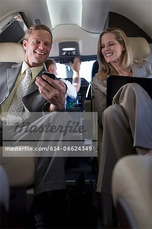 Business people talking in airplane