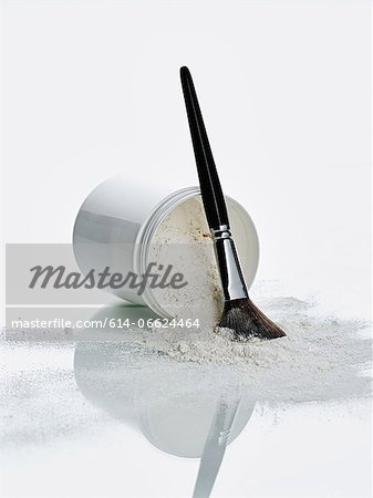 Makeup brush in pile of powder