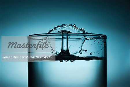 Drop splashing in glass of water